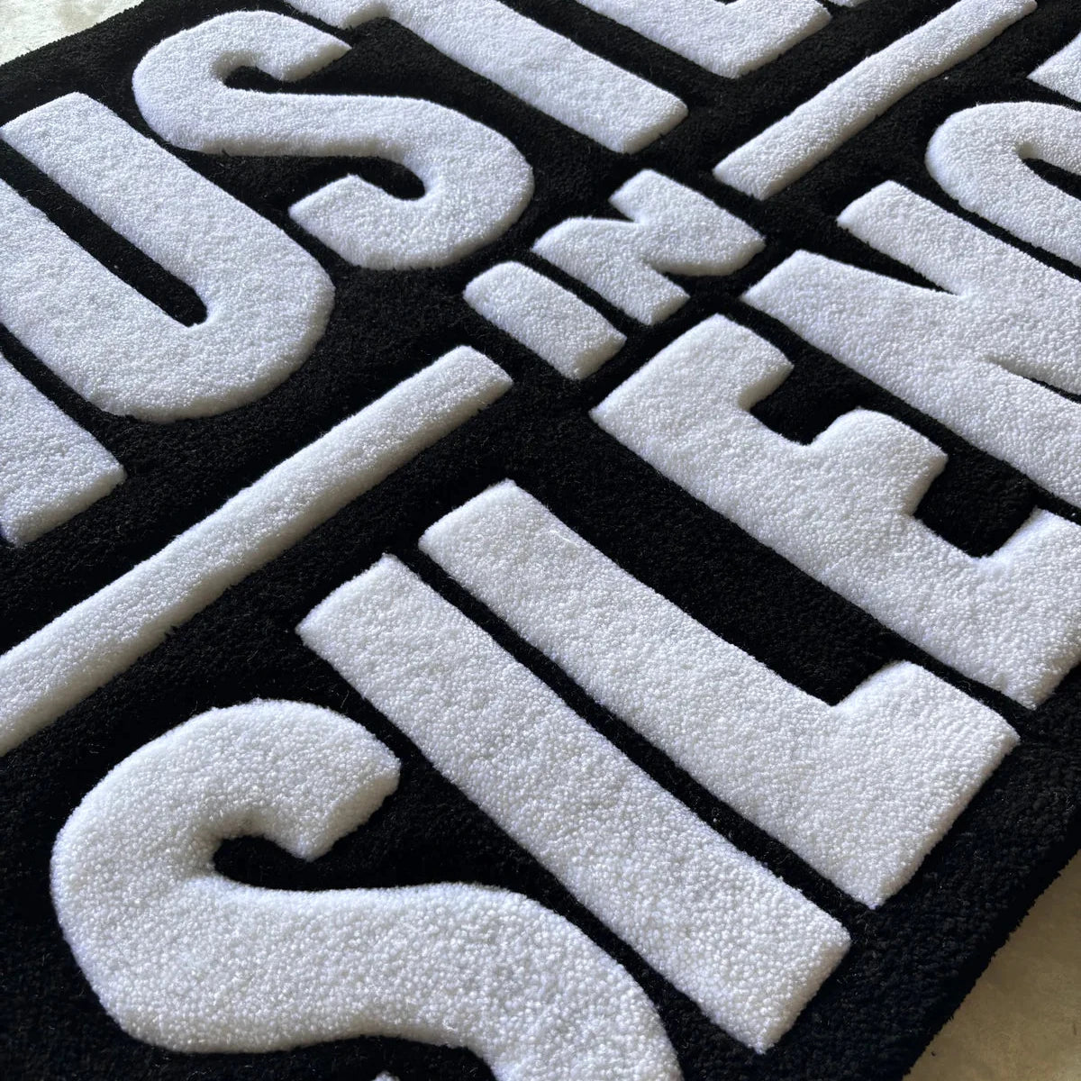"HUSTLE IN SILENCE" RUG